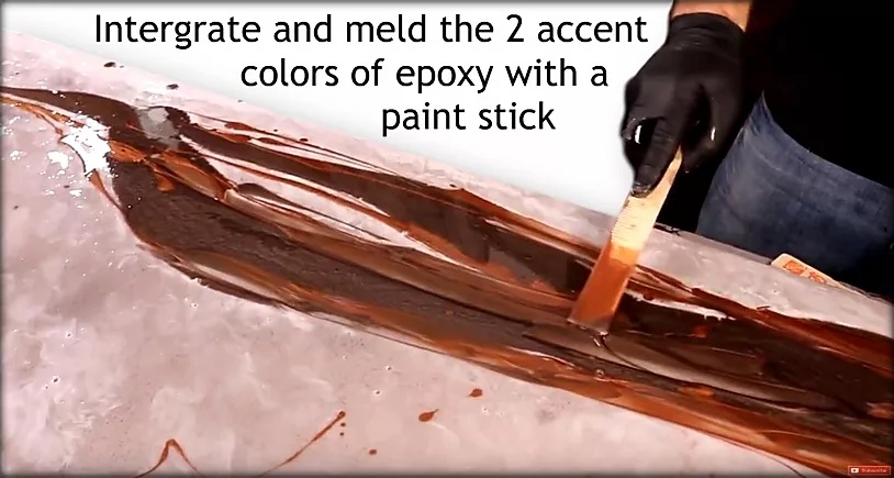Integrate and meld the two accent colors of epoxy with a paint stick