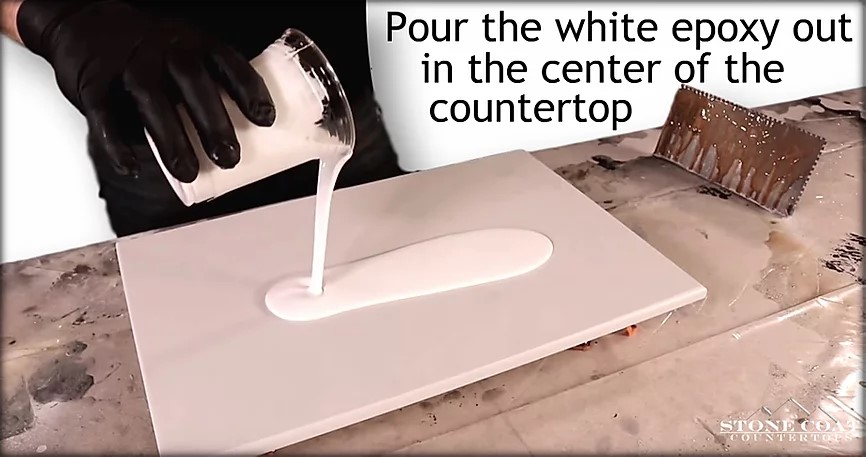 Pouring white epoxy for marble over a tinted natural gray base layer